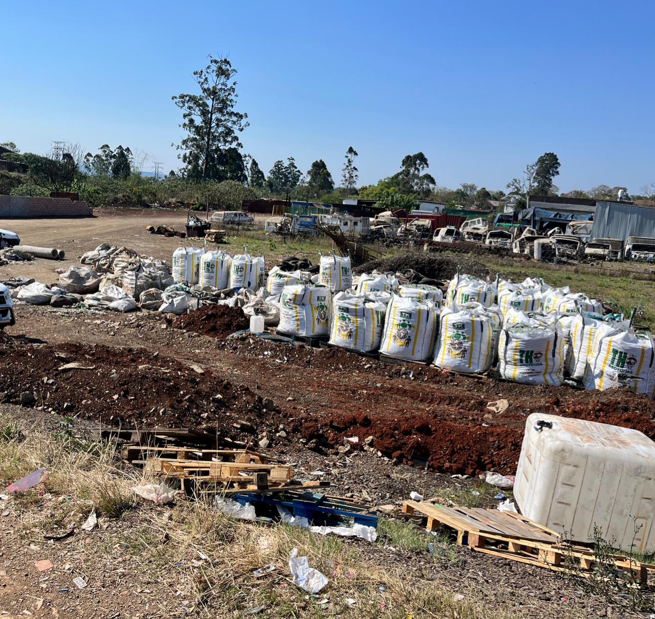 Amabongo Solutions weighing station at the Mkondeni recycling depot with sorted green and brown glass bottles.