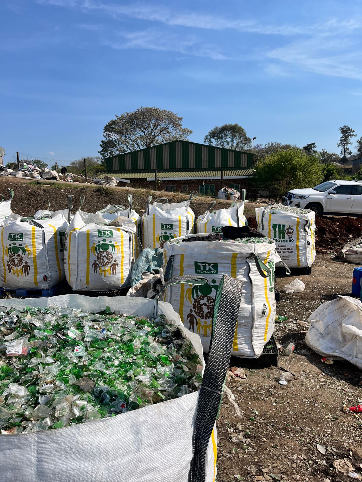 Amabongo Solutions recycling plant in Pietermaritzburg preparing mixed-color glass bottles for sorting and processing.